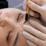 beautician doing microblading procedure client s eyebrows