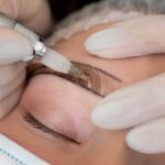 beautician working client s eyebrows