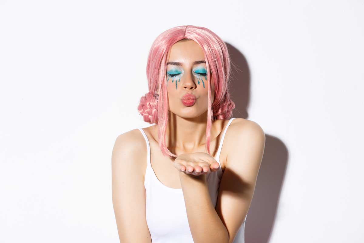 close up lovely girl halloween costume with pink wig bright makeup close eyes blowing air kiss camera standing 1