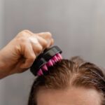 man giving himself scalp massage